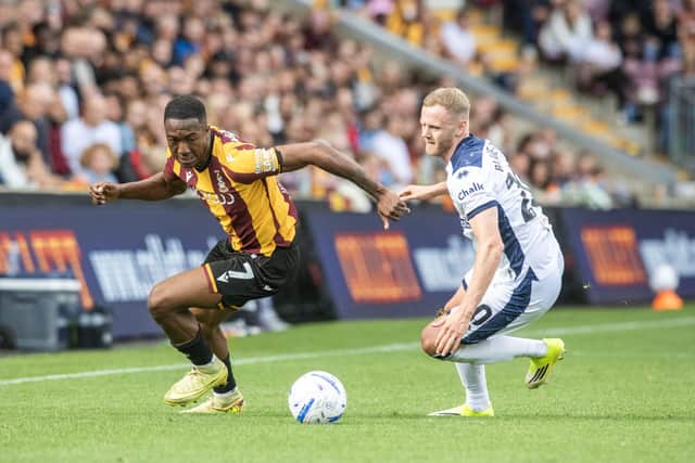 Bradford City's Josh Neufville spins round Mansfield Town's Frazer Blake-Tracy at Valley Parade. Photo: Tony Johnson.