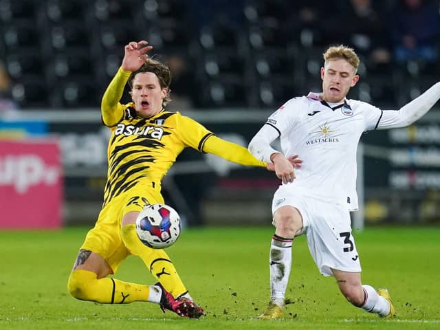 HARD BATTLE: Rotherham United's Leo Hjelde is fouled by Swansea City's Oli Cooper (right) during Monday night's Championship match at the Swansea.com Stadium Picture: Nick Potts/PA
