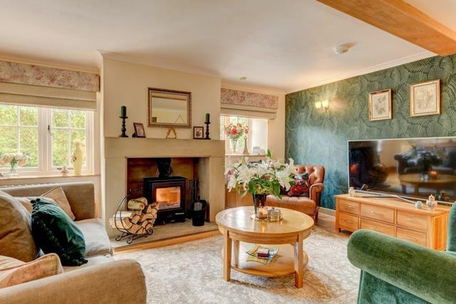 The stylish sitting room with cosy wood-burning stove and great views