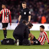 SIDELINED: Sheffield United's Iliman Ndiaye receives treatment during the clash at Bramall Lane on Saturday and is now doubtful. 
Isaac Parkin/PA