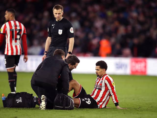 SIDELINED: Sheffield United's Iliman Ndiaye receives treatment during the clash at Bramall Lane on Saturday and is now doubtful. 
Isaac Parkin/PA