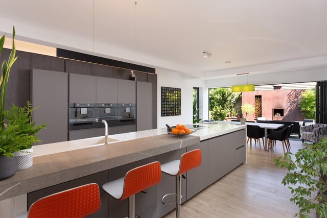 The kitchen with large island and breakfast bar show off the owners design skills in creating a semi open plan area that flows and integrates superbly