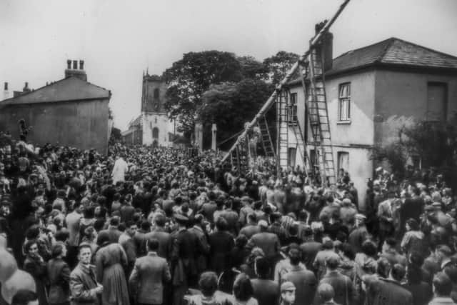The triannual raising of the Maypole in a snap from 1954 which features on the village noticeboard.