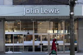 A woman walks past the now closed John Lewis store in Sheffield