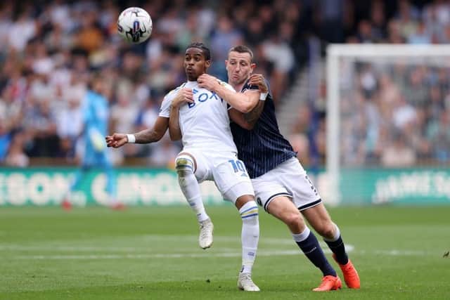 LONDON, ENGLAND - SEPTEMBER 17: Crysencio Summerville of Leeds United is challenged by Murray Wallace of Millwall during the Sky Bet Championship match between Millwall and Leeds United at The Den on September 17, 2023 in London, England. (Photo by Alex Pantling/Getty Images)
