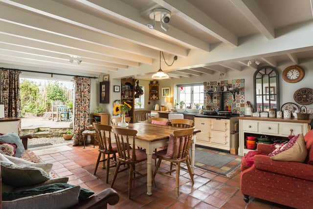 The fabulous country kitchen is spacious and includes an AGA