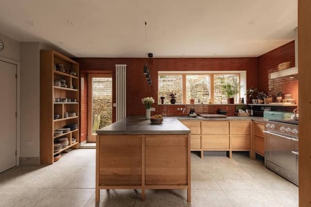 In the kitchen, caramel-glazed tiles by Ca’Pietra pair with poured-concrete worktops and bespoke solid oak cabinetry, creating a warm yet contemporary feel.