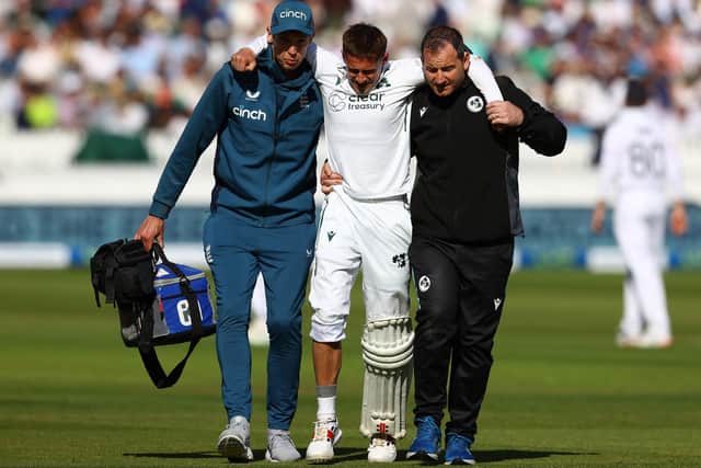 BAD KNOCK: Ireland's James McCollum is helped off the field after retiring injured after being struck on his knee from a Josh Tongue delivery on day two at Lord's Picture: Michael Steele/Getty Images