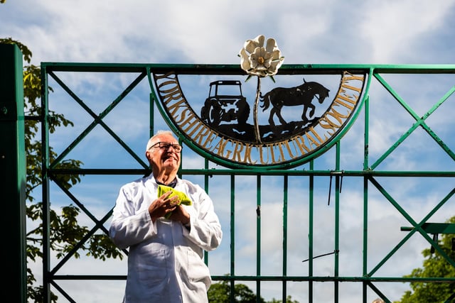 Gate steward, Brian Cooksey, aged 68, dusting off Yorkshire Agricultural Society signage on one of the show gates ahead first day starting tomorrow.