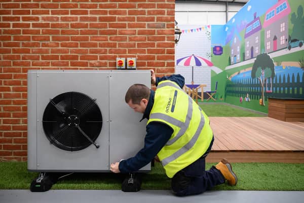 An engineer checks the installation of a heat pump on a model house. PIC: Leon Neal/Getty Images