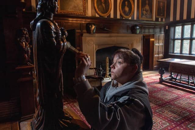 Sarah Todexco cleaning a statue in the main hall at Shibden Hall as they prepare for reopening. Picture Bruce Rollinson