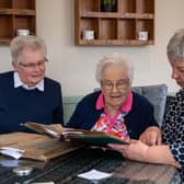 William Cooke's daughter, Betty Longbottom, and his granddaughters Pam Hooper and Anna Buehring, looking through his clipping books from he worked as a sanitary inspector in Bingley in the 1930s-1950s. Picture: Bruce Rollinson.