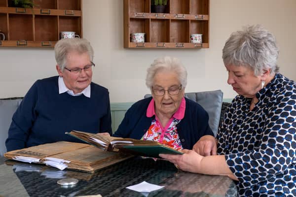 William Cooke's daughter, Betty Longbottom, and his granddaughters Pam Hooper and Anna Buehring, looking through his clipping books from he worked as a sanitary inspector in Bingley in the 1930s-1950s. Picture: Bruce Rollinson.