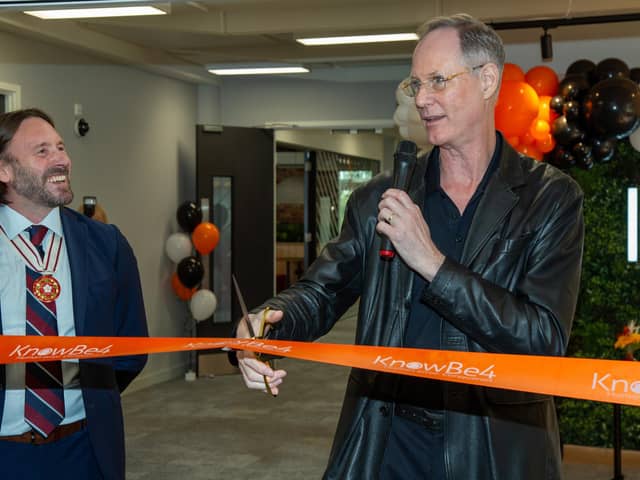 Stu Sjouwerman, founder and CEO of KnowBe4 (right), cuts a ribbon at the opening ceremony of KnowBe4's new Leeds office. Photo: Roth Read Photography.