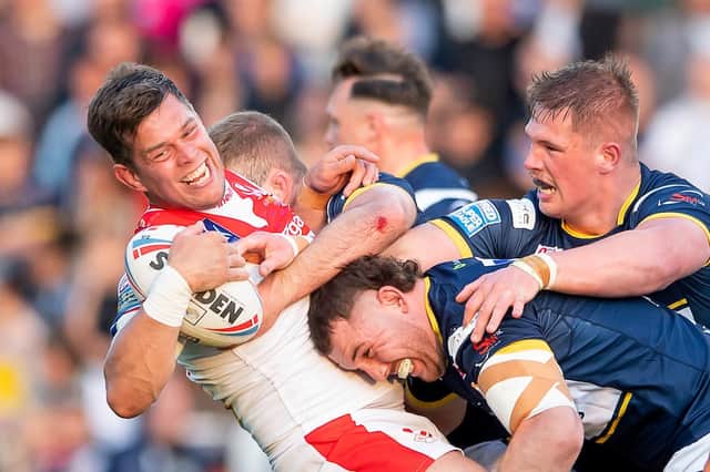 Picture by Allan McKenzie/SWpix.com - 26/05/2023 - Rugby League - Betfred Super League Round 13 - Leeds Rhinos v St Helens - Headingley Stadium, Leeds, England - St Helens's Louie McCarthy-Scarsbrook is tackled by Leeds's Cameron Smith & Tom Holroyd.