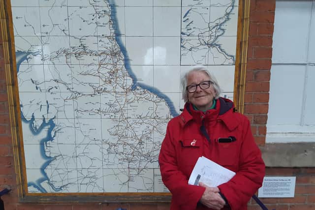 Beverley historian Professor Barbara English by the rare tiled railway map in Beverley Station, showing the never built North Holderness Railway.