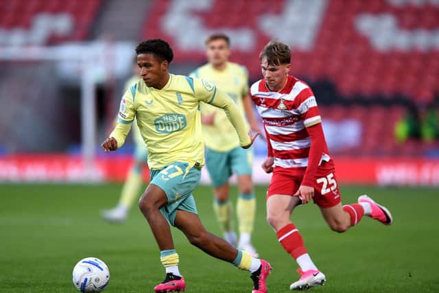 Huddersfield Town's Jay Sway gets away from Doncaster Rovers' rival Bayley McCann. Picture: Jonathan Gawthorpe