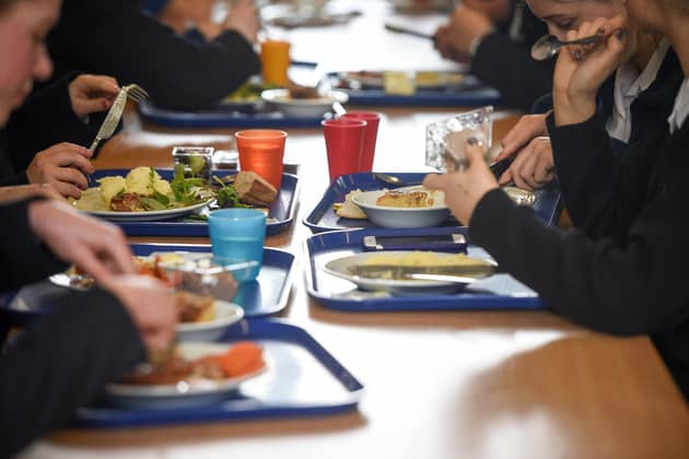 Children eating their school dinner from trays and plates during lunch. PIC: Ben Birchall/PA Wire
