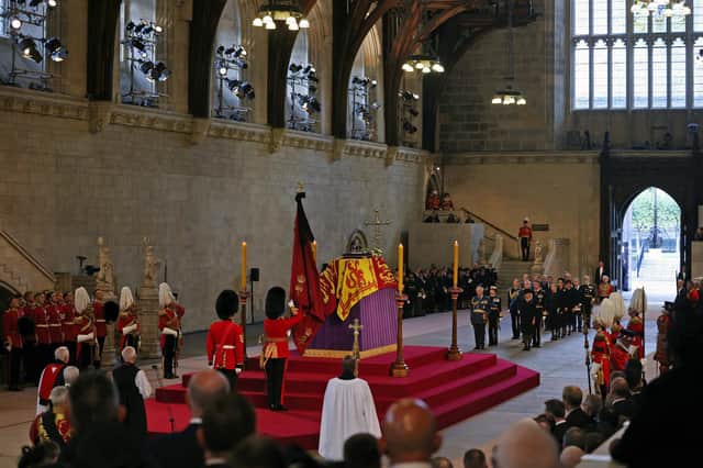 The coffin of Queen Elizabeth II, draped in the Royal Standard with the Imperial State Crown placed on top, lays on the catafalque in Westminster Hall, London, where it will lie in state ahead of her funeral on Monday. Picture date: Wednesday September 14, 2022.