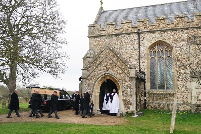 The hearse carrying Baroness Betty Boothroyd’s coffin has arrived at a church in the Cambridgeshire village she called home before her death last month aged 93. A white floral tribute lies on top of the coffin.