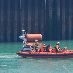 Two men thought to be migrants are brought in to the Border Security Command compound in Dover, Kent, onboard an RNLI vessel. PIC: Gareth Fuller/PA Wire