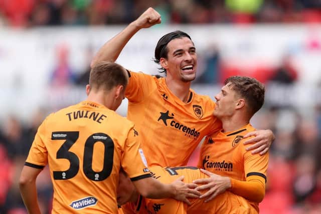 : Regan Slater of Hull City celebrates with teammates after scoring the team's third goal. (Photo by Charlotte Tattersall/Getty Images)