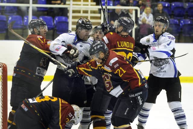 GOOD TIMES: Sheffield Steeldogs' player-coach Andre Payette (second left) and team-mate Greg Wood (third left) jostle with Guildford Flames players during the final of the EPL Cup Final. Picture: Steve Ellis/Johnston Press.