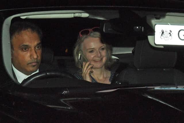 File photo dated 25/9/2019 of Liz Truss using a mobile phone while being driven out of the House of Commons, London. The Government has been urged to launch an urgent investigation following reports that Truss's phone was hacked.Picture: Kirsty O' Connor/PA Wire