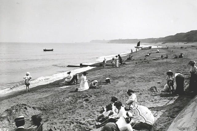 People lying on the sand in Sandsend beach in the early 1900s.
