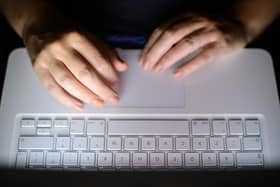 A stock photo shows a woman's hands using a laptop keyboard. PIC: Dominic Lipinski/PA Wire
