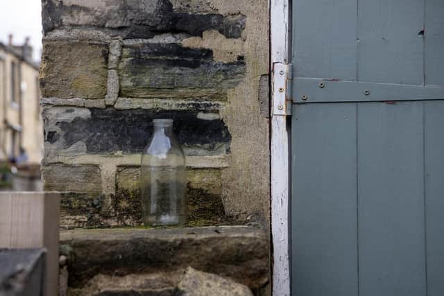 A milk bottle in by the old outside toilet.