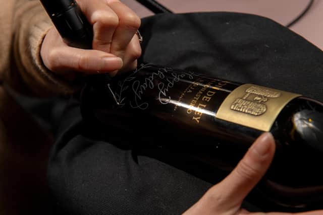 Tracey Ho, caligrapher, at work engraving a wine bottle. Picture Bruce Rollinson
