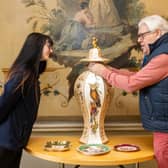 Wentworth Woodhouse archivist David Allott and front of house officer Emily Atkin examine a piece from the Trust’s Rockingham Pottery collection