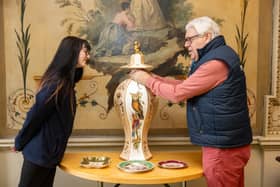 Wentworth Woodhouse archivist David Allott and front of house officer Emily Atkin examine a piece from the Trust’s Rockingham Pottery collection