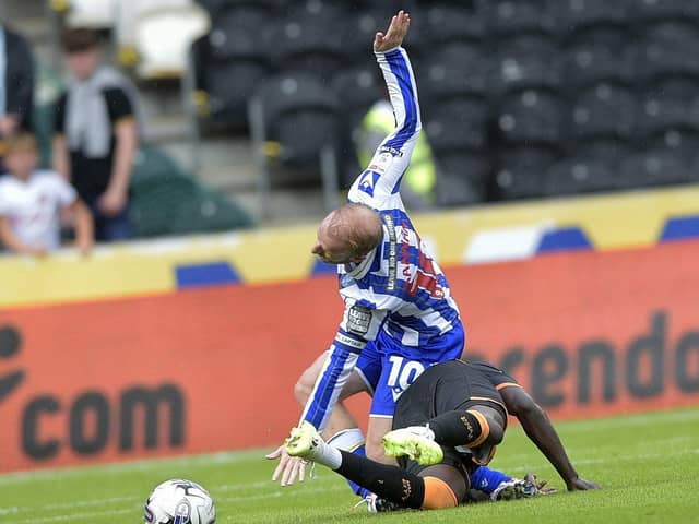 Sheffield Wednesday captain Barry Bannan is challenged by Hull City's Jason Lokilo. Picture: Steve Ellis.