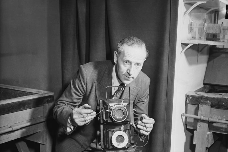 Fox Photos photographer, Reg Speller, on May 29, 1953, with the double camera he will use at the coronation of The Queen.