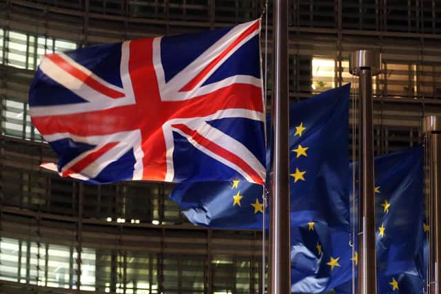 A picture taken on December 9, 2020 shows a Union Jack and European flags fluttering outside the Berlaymont building, the European commission headquarters. PIC: FRANCOIS WALSCHAERTS/AFP via Getty Images