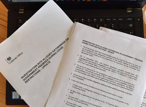 A photo illustration shows a printed out version of the update on the investigation into alleged gatherings on government premises during Covid restrictions on January 31, 2022. (Pic credit: John Keeble / Getty Images)