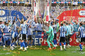 GOING UP: Sheffield Wednesday players celebrate with the trophy and promotion to the Championship following victory over Barnsley in the League One play-off final at Wembley Picture: Nick Potts/PA