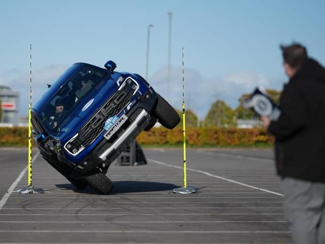 Stunt driver Paul Swift who has achieved the Guinness World Records title for the tightest gap driven through by a pickup truck on two wheels with an incredible 88cm, which has been done in celebration of Guinness World Records Day 2023. Guinness World Records/PA Wire