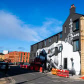 Artist known as Phlegm a Welsh-born Sheffield-based muralist and artist working on a massive mural on the side of the former Eye Witness Works at the junction of Hilton Street, and Headford Street in Sheffield.