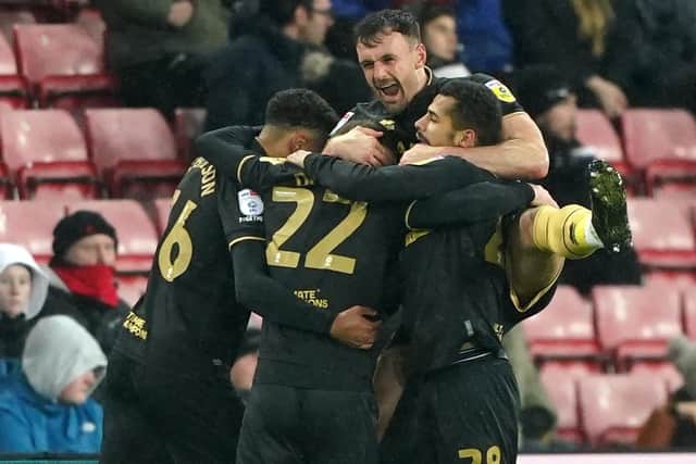 Back on track: Sheffield United's Tommy Doyle (back to camera) is mobbed by team-mates after scoring the winning goal at Sunderland. (Picture: Owen Humphreys/PA)