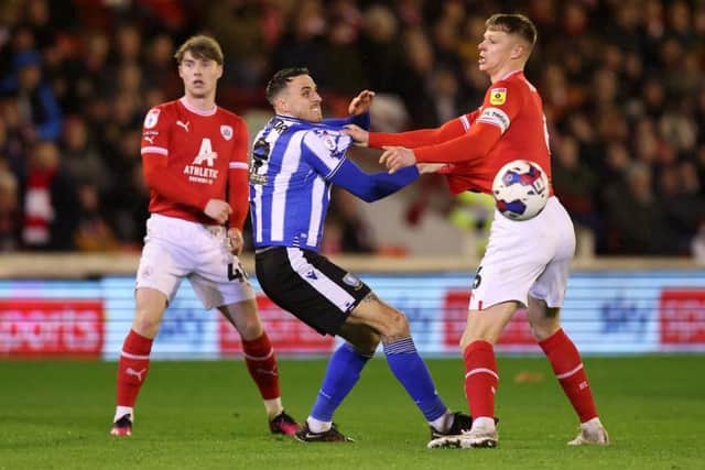 FIGHTER: Sheffield Wednesday's Lee Gregory, pictured tussling with Barnsley's Mads Andersen