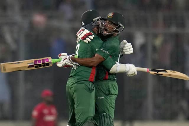 Bangladesh's Najmul Hossain Shanto, right, and Taskin Ahmed celebrate after their win in the the second T20 cricket match against England in Dhaka (AP Photo/Aijaz Rahi)