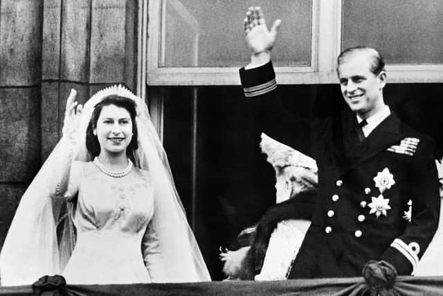 Queen Elizabeth II and Prince Philip, Duke of Edinburgh wave at their wedding, on November 20, 1947, in London.