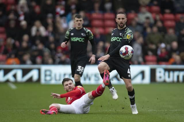 Barnsley's Nicky Cadden challenges Rams' Conor Hourihane. (Picture: Tony Johnson)