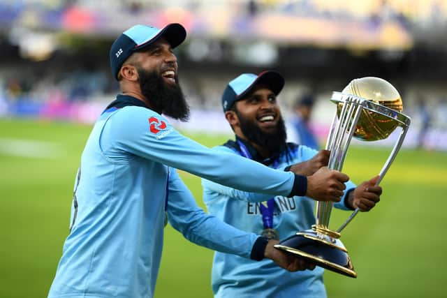 Moeen Ali of England and Adil Rashid of England parade the trophy after the Final of the ICC Cricket World Cup 2019 between New Zealand and England at Lord's Cricket Ground on July 14, 2019 (Picture: Clive Mason/Getty Images)