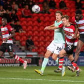 GOAL THREAT: Mo Faal (far right) heads at goal for Doncaster Rovers