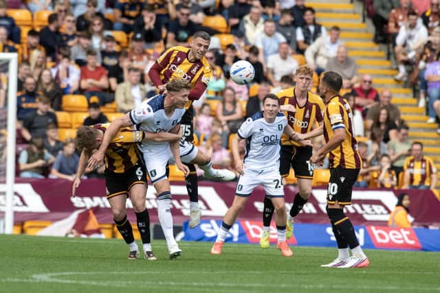 Bradford City defender Aden Baldwin wins the air miles against Mansfield Town as debutant George Pratt (second right) looks on. Photo: Tony Johnson.