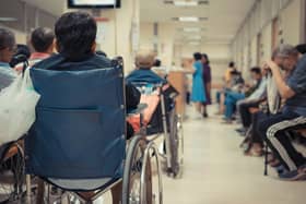 Patient elderly on wheelchair and many patient waiting a doctor and nurse in hospital - stock